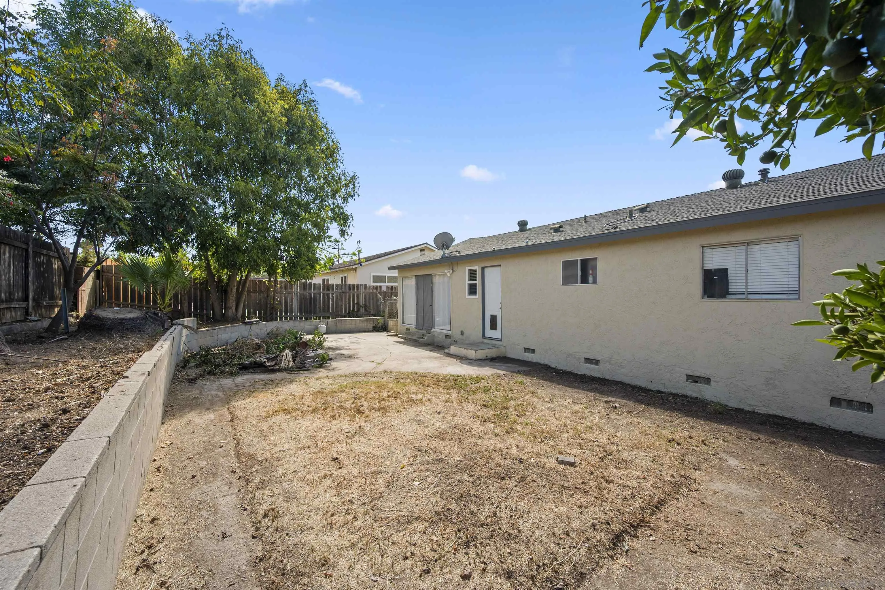 8740 Adriana Street Spring Valley, CA 91977 - Photo 25 of 32 a view of a backyard with a tree