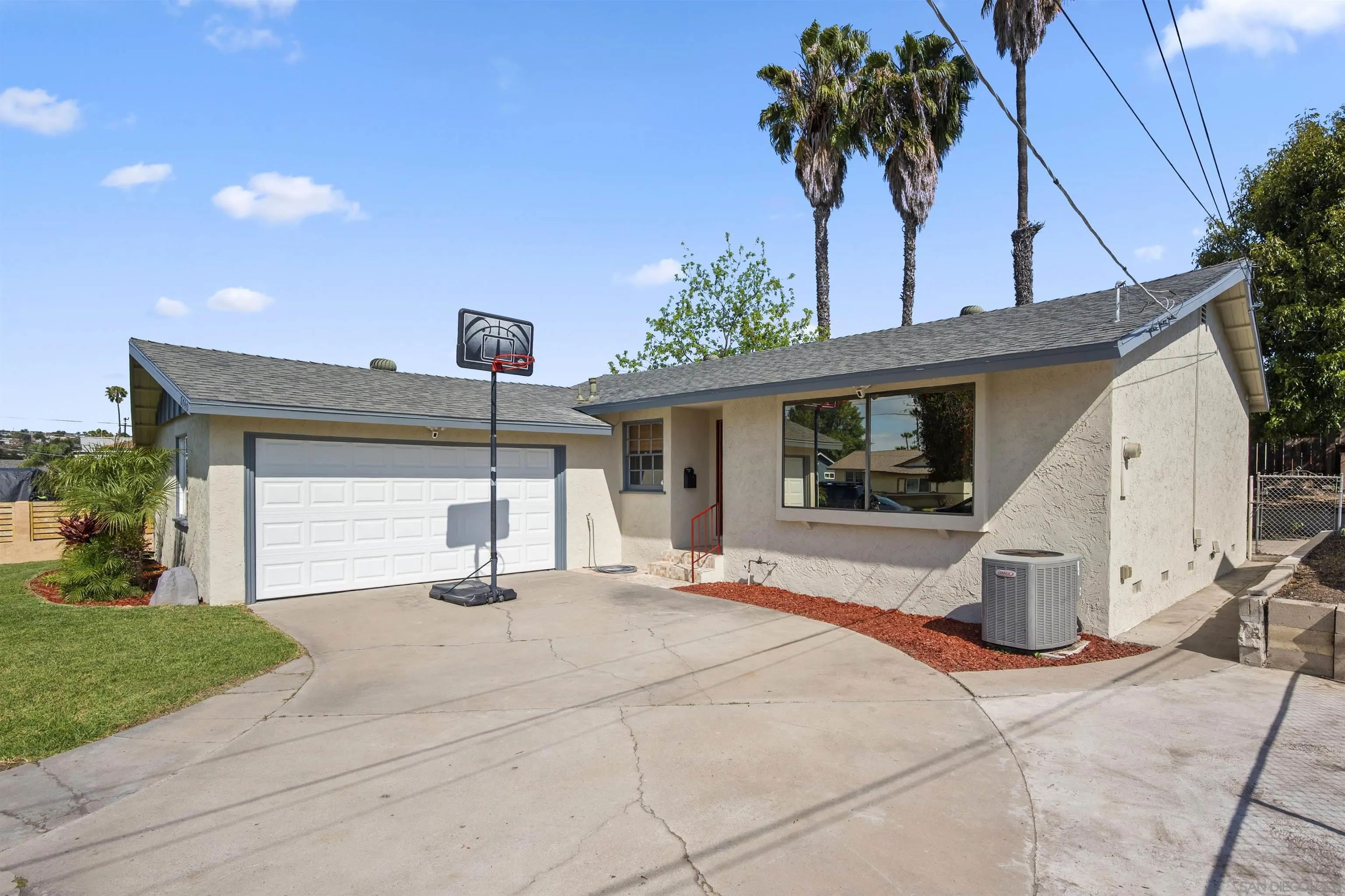 8740 Adriana Street Spring Valley, CA 91977 - Photo 28 of 32 a view of a house with backyard and a garden
