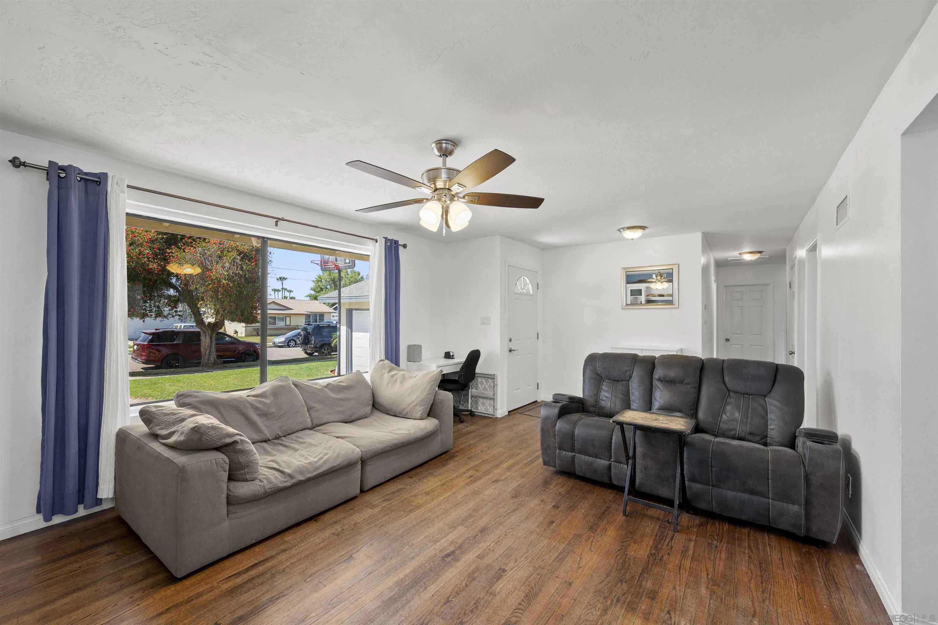8740 Adriana Street Spring Valley, CA 91977 - Photo 4 of 32 a living room with furniture and a large window