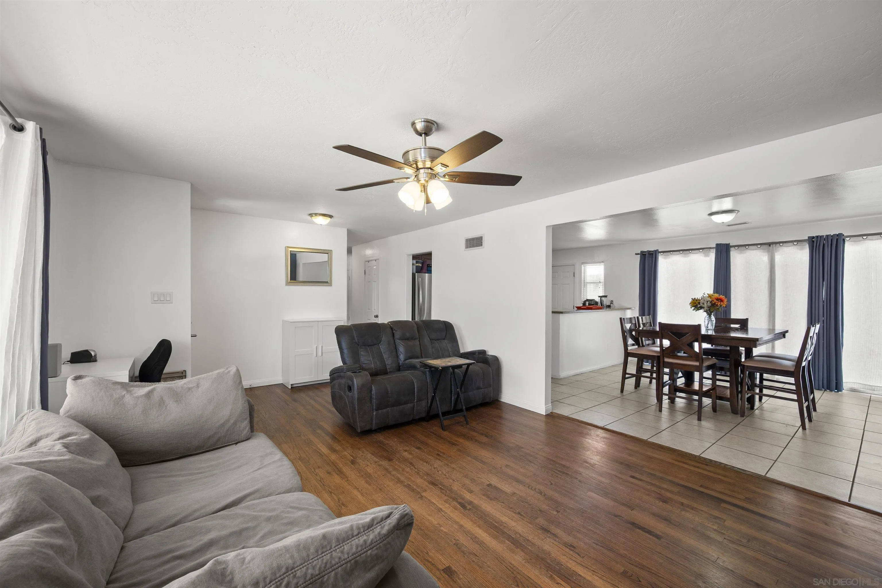 8740 Adriana Street Spring Valley, CA 91977 - Photo 5 of 32 a living room with furniture and wooden floor