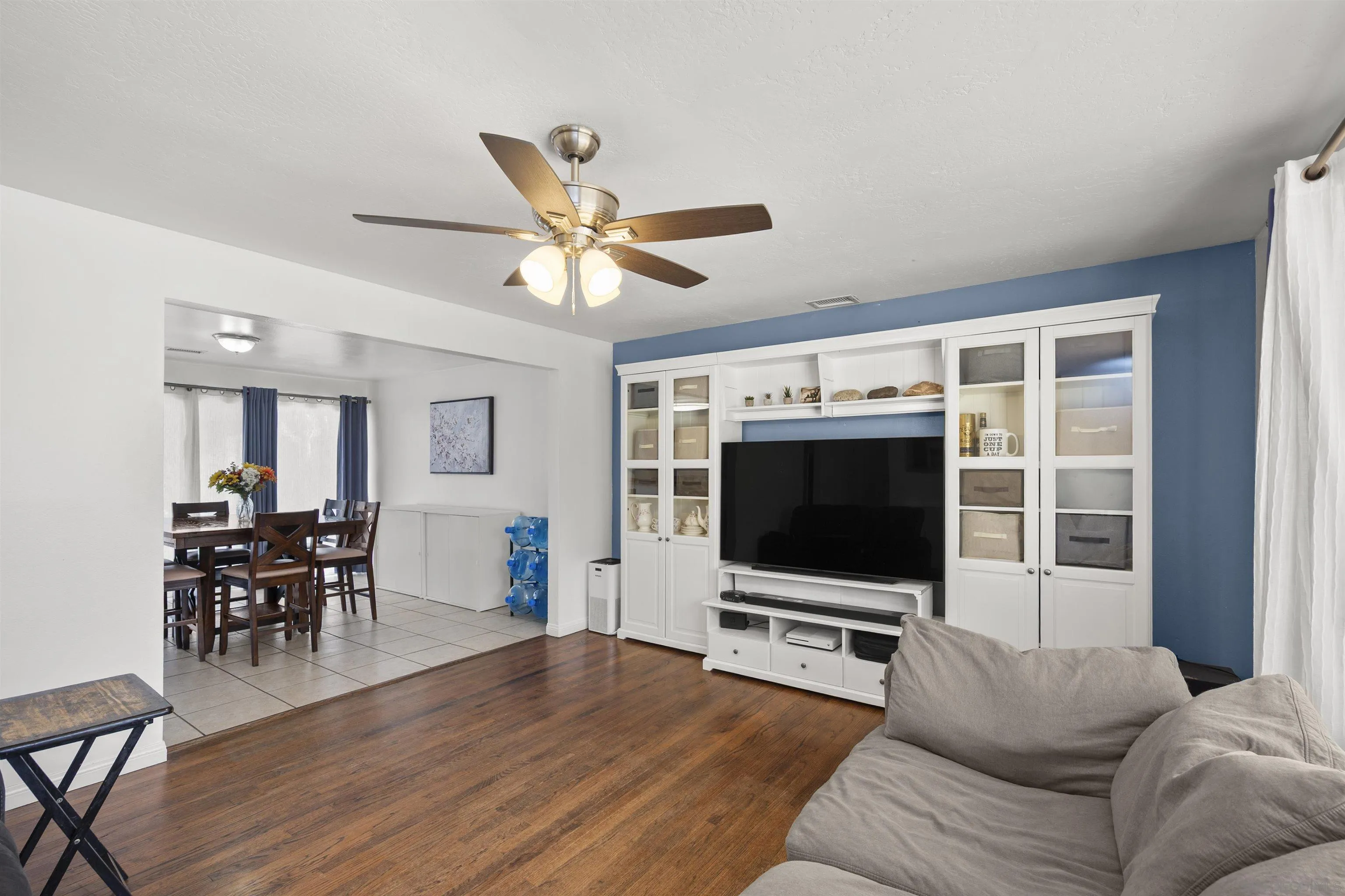 8740 Adriana Street Spring Valley, CA 91977 - Photo 6 of 32 a living room with furniture and a flat screen tv