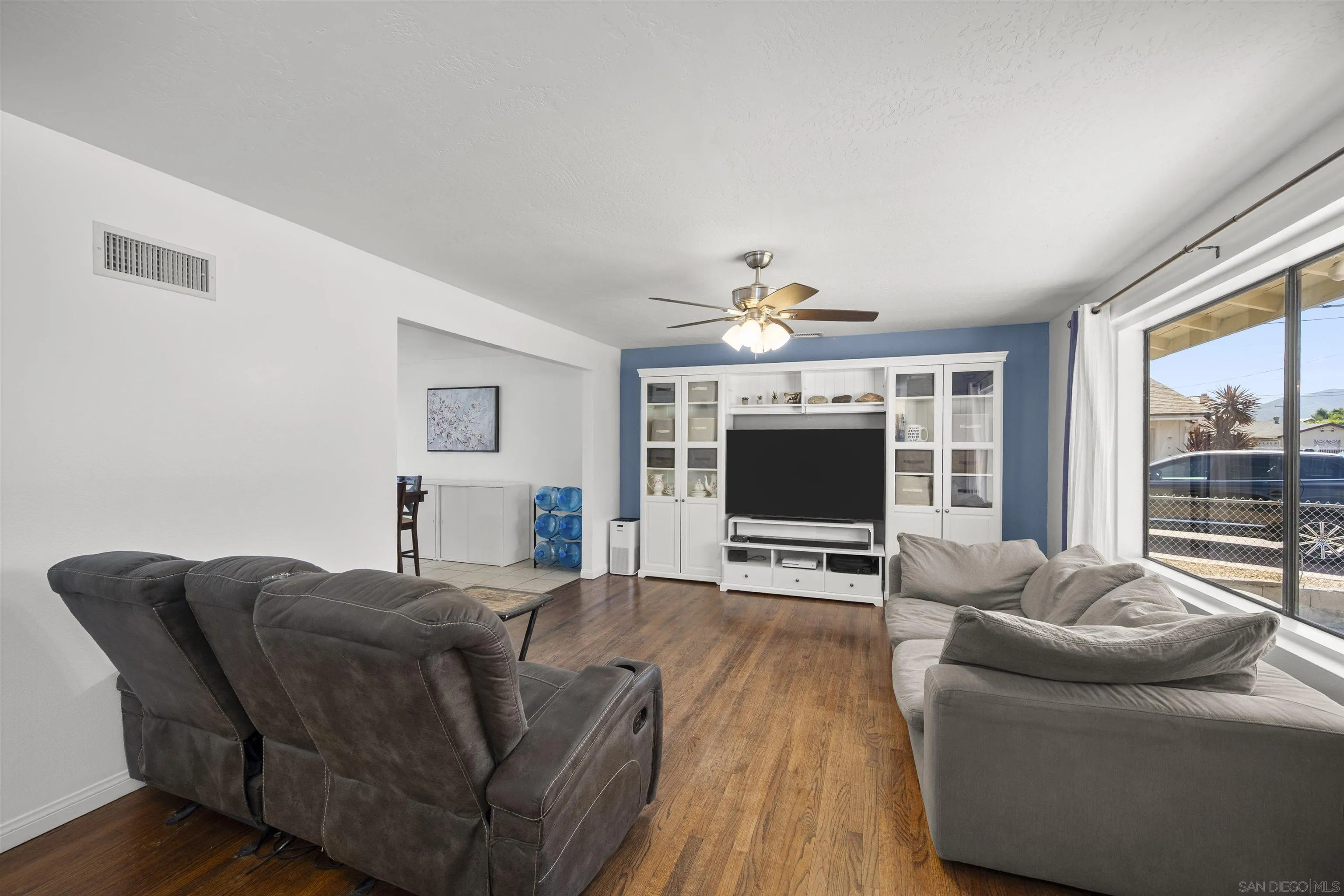 8740 Adriana Street Spring Valley, CA 91977 - Photo 7 of 32 a living room with furniture and a flat screen tv