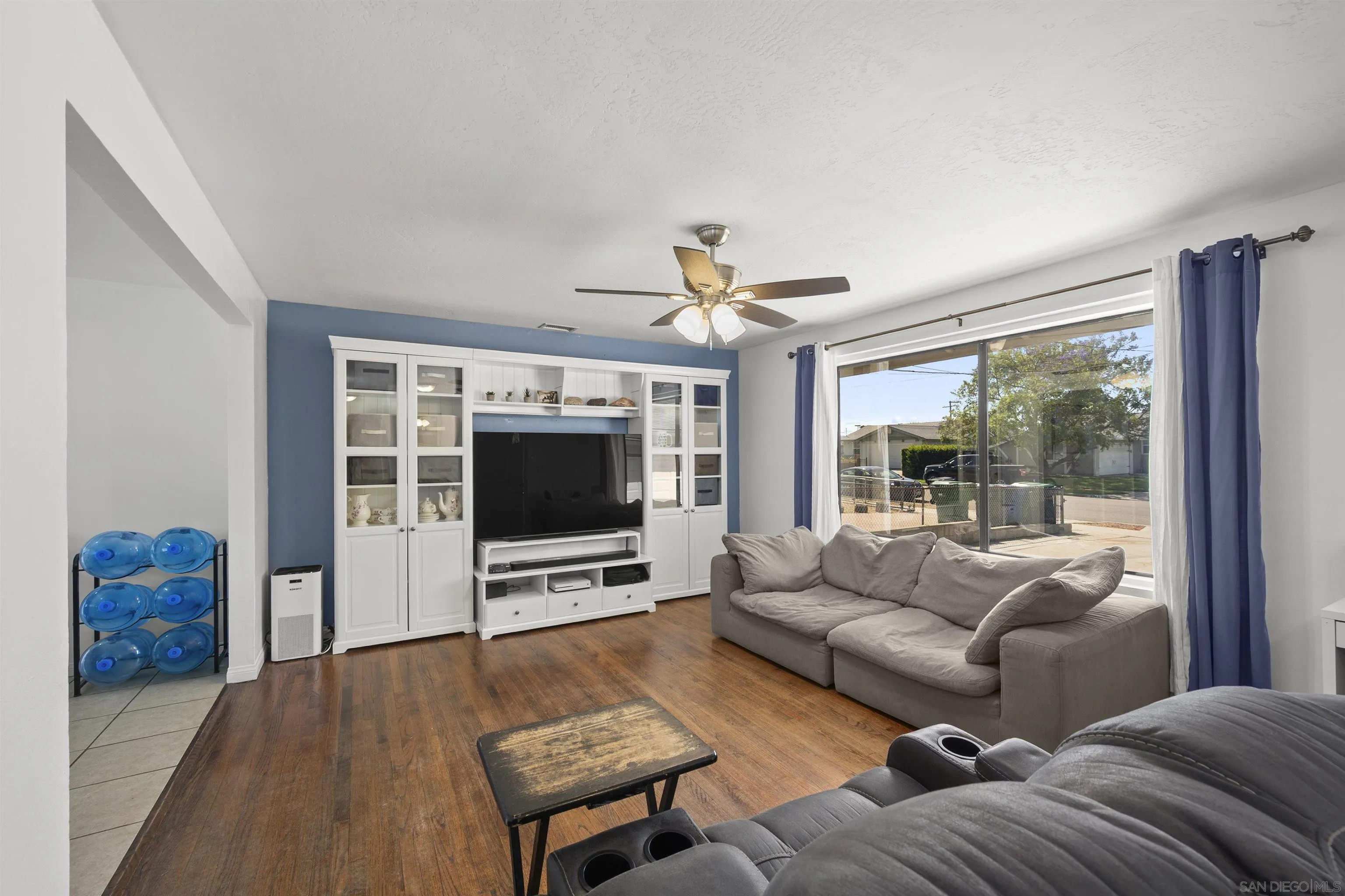 8740 Adriana Street Spring Valley, CA 91977 - Photo 8 of 32 a living room with furniture and a flat screen tv