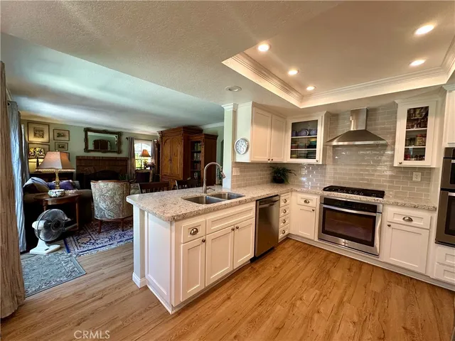 a kitchen with a stove top oven sink and a refrigerator