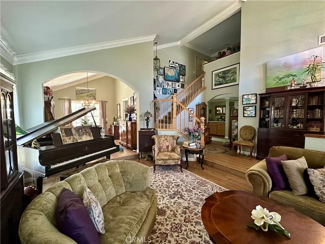 a living room with furniture chess board and a floor to ceiling window