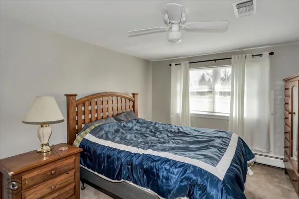 a bedroom with a bed closet and a window