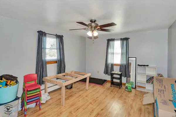 a living room with furniture a air conditioner vent and a window