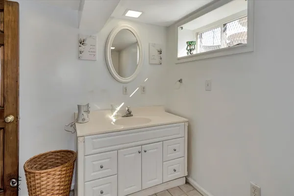 a bathroom with a sink a mirror and vanity