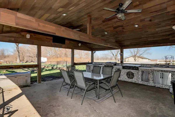 a view of a patio with table and chairs