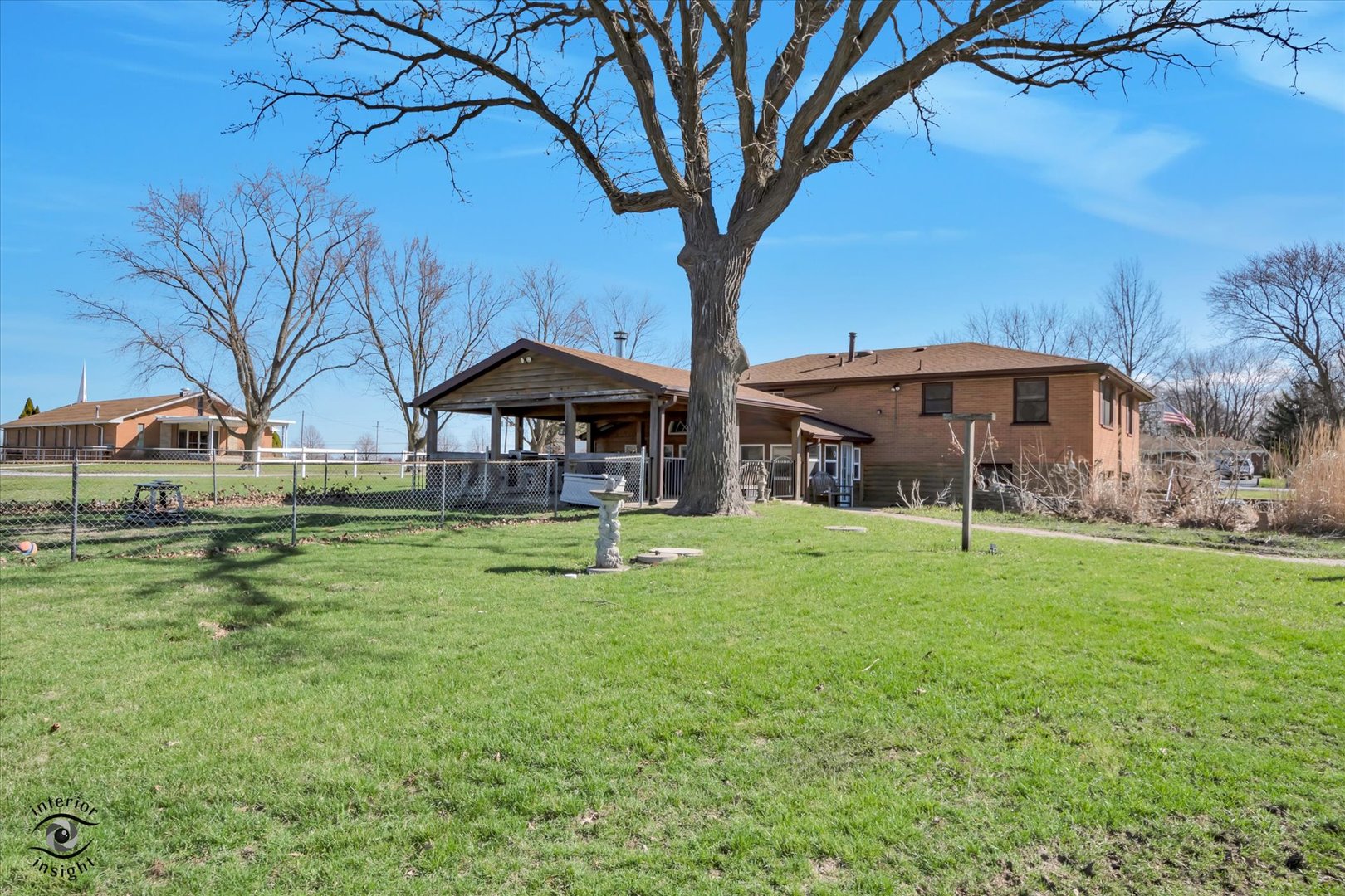 3230 North Glenn Road Bourbonnais, IL 60914 - Photo 32 of 34 a view of a house with a yard table and chairs under an umbrella