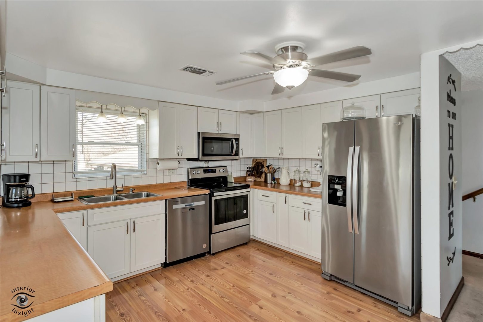 3230 North Glenn Road Bourbonnais, IL 60914 - Photo 8 of 34 a kitchen with stainless steel appliances a sink a stove a refrigerator cabinets and a window
