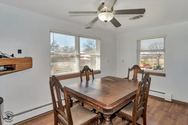 a view of a dining room with furniture and a window