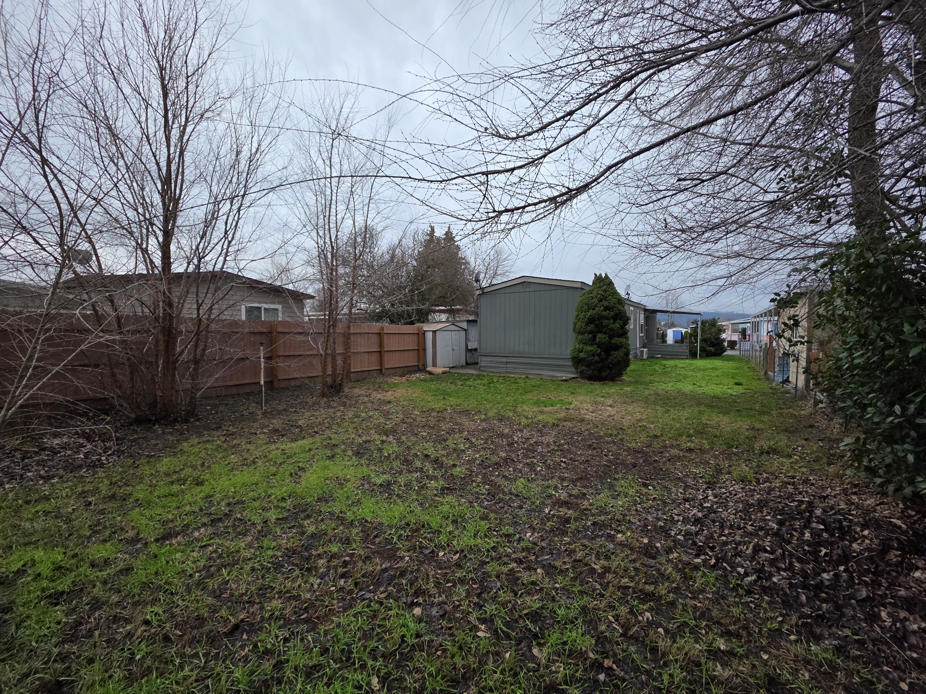 301 Freeman Road, Unit 30 Central Point, OR 97502 - Photo 14 of 26 a view of a backyard with large trees