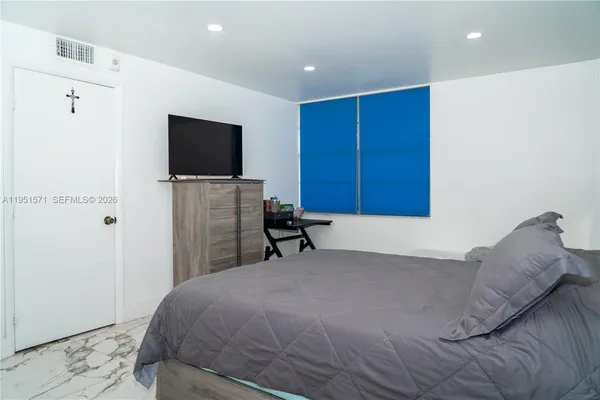 a bed room with a bed and a television