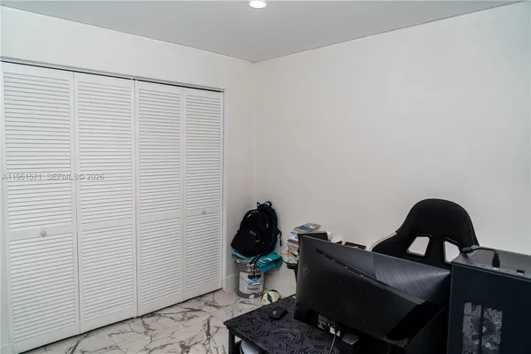 a room with a chair and a potted plant