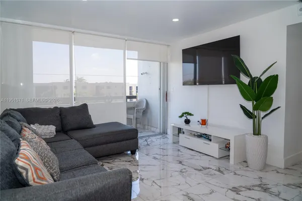 a living room with furniture and a flat screen tv
