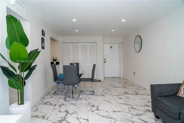 a view of a livingroom with furniture and a potted plant