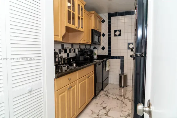 a kitchen with a refrigerator and cabinets