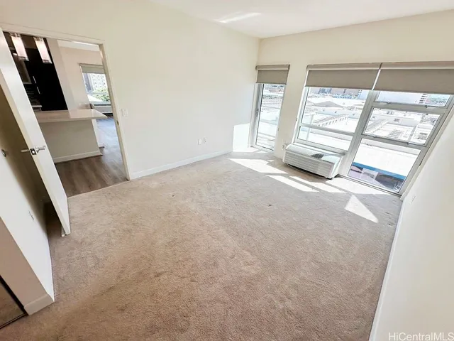 a view of a room with refrigerator and white walls