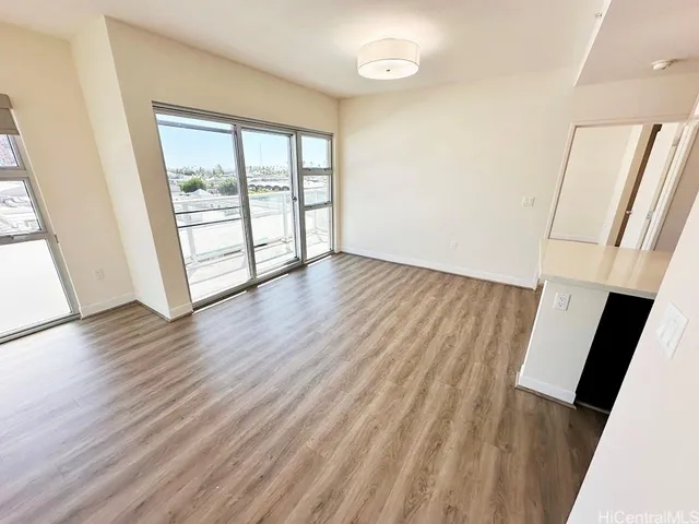 a view of a kitchen with a sink and dishwasher a stove top oven with wooden floor