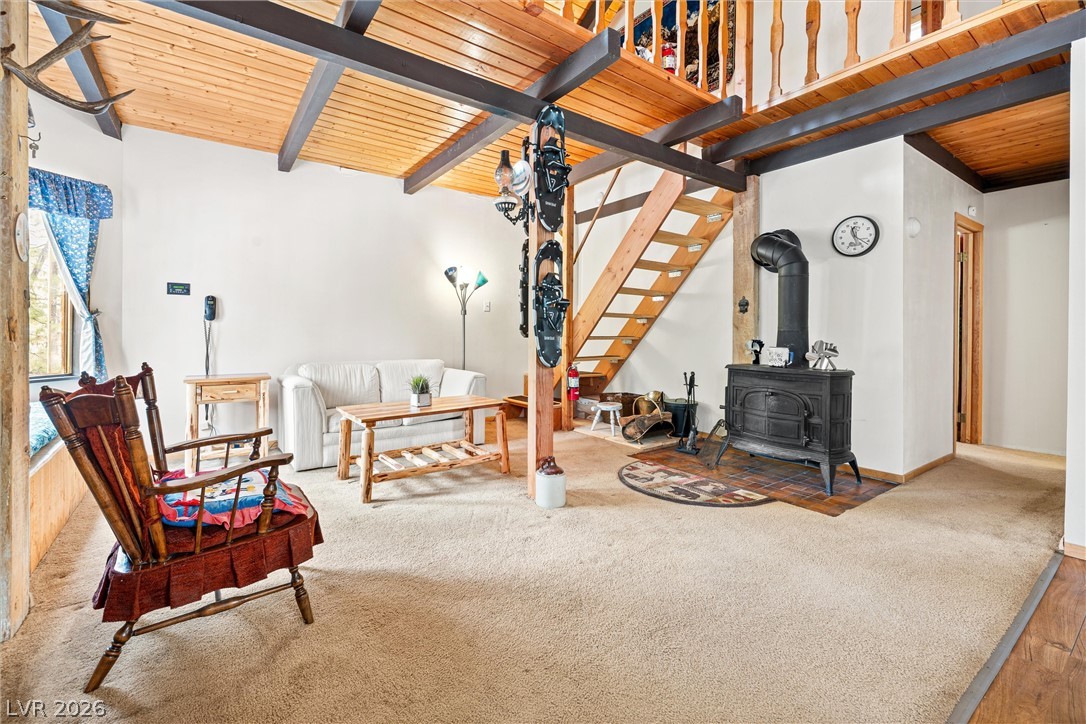 2146 Via Spes Nostra Street Mount Charleston, NV 89124 - Photo 12 of 33 A striking wood-burning stove grounds this cozy living area beneath soaring exposed beam ceilings and a rustic open staircase.