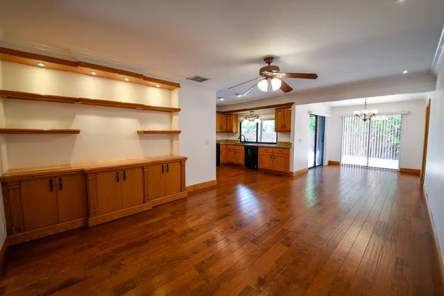a view of kitchen with sink and refrigerator