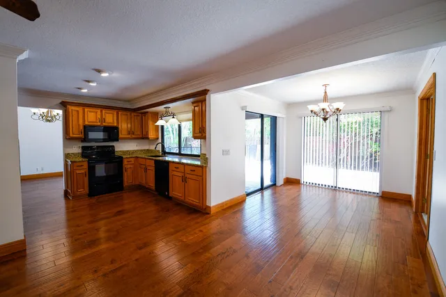 a view of kitchen with sink and refrigerator