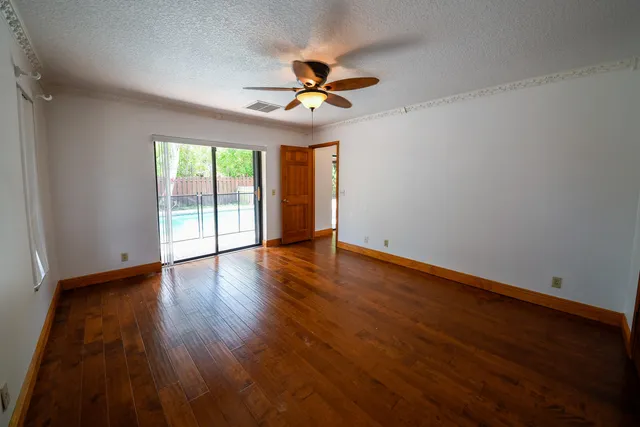 a view of walk in closet with wooden floor and a window