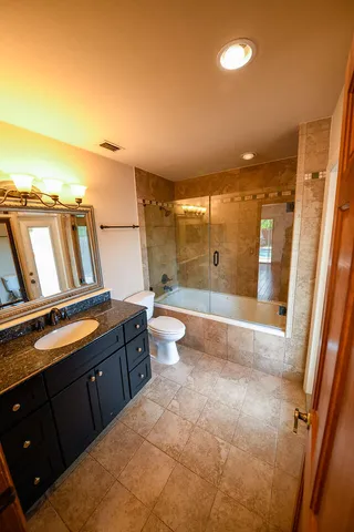 a bathroom with a bathtub and a shower