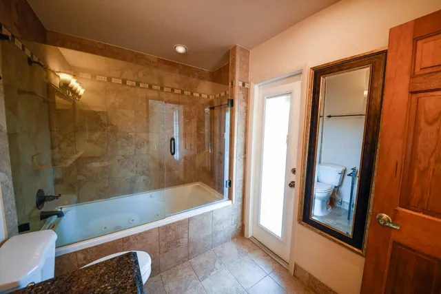 a view of an empty room with a window and staircase