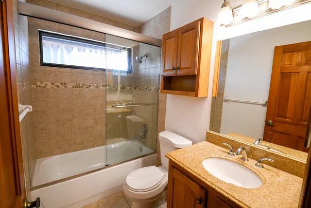 an empty room with windows and cabinet