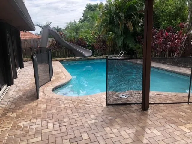 a view of an outdoor dining space with a table and chairs