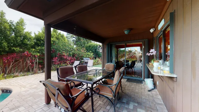 a view of a backyard with a small cabin and wooden fence
