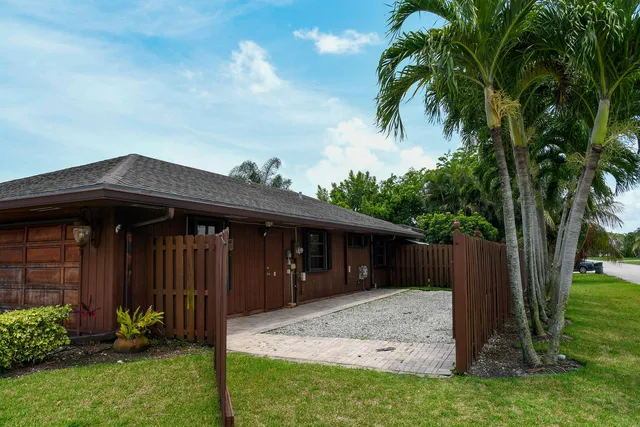 a view of house with yard and entertaining space