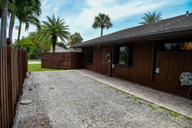 a front view of house with a garden