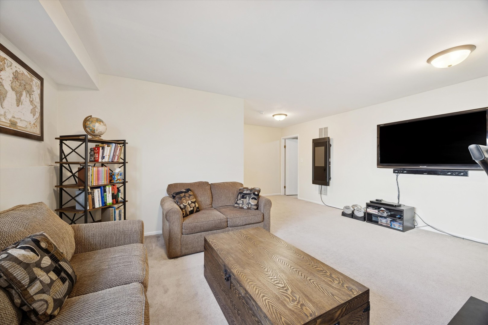 351 Park Ridge Lane, Unit D Aurora, IL 60504 - Photo 11 of 29 a living room with furniture and a flat screen tv