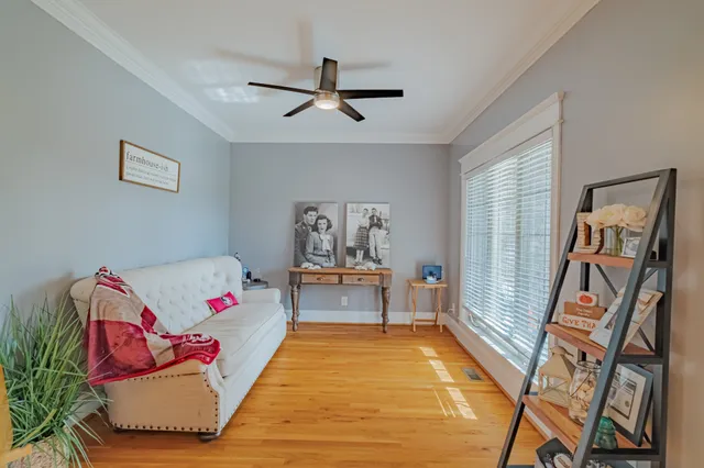 a hallway with a couch and chandelier
