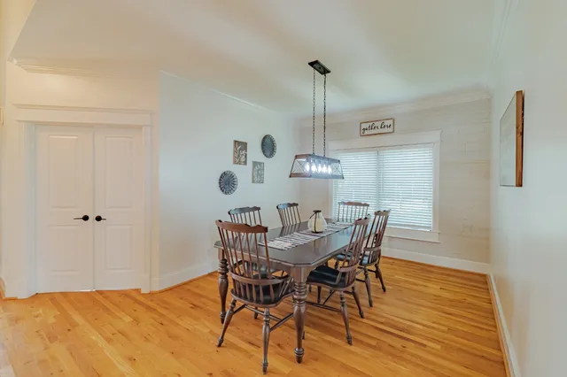 a view of a dining room with furniture and wooden floor