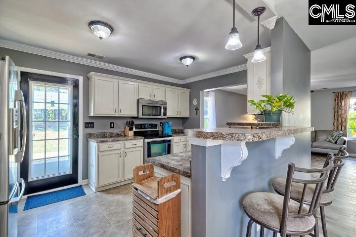 209 Eagle Pointe Drive Chapin, SC 29036 - Photo 12 of 40 a kitchen with microwave a stove and refrigerator