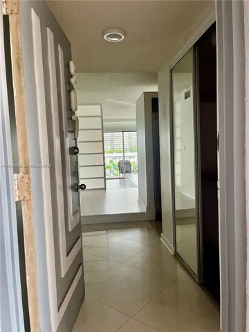 a view of a hallway with windows and cabinet