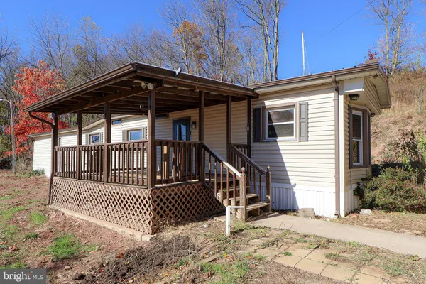 a view of a brick house with wooden fence and floor