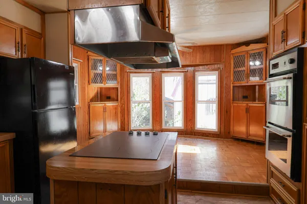 a view of empty room with a window and wooden floor