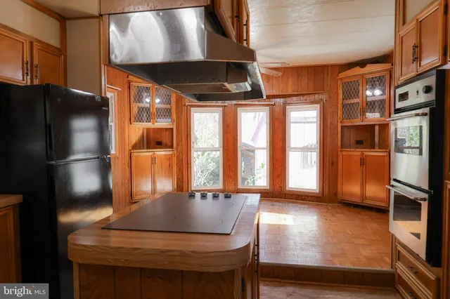 a view of empty room with a window and wooden floor