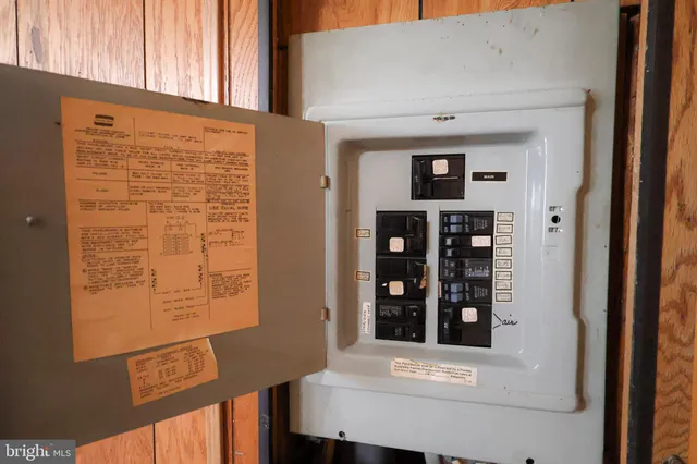 an empty room with wooden floor and closet area