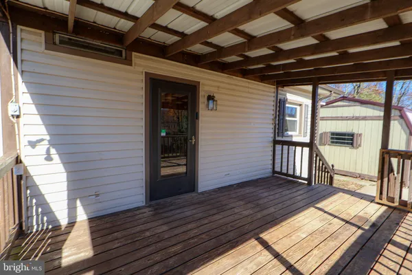 a view of a porch with wooden floor