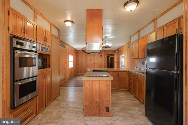 a kitchen with granite countertop a sink and a window