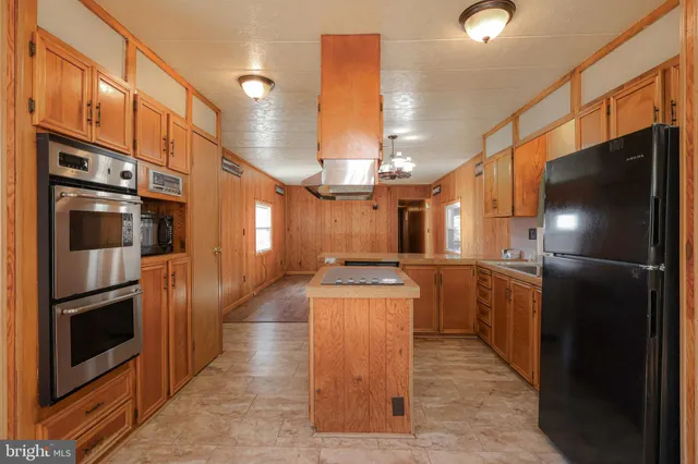 a kitchen with granite countertop a sink and a window