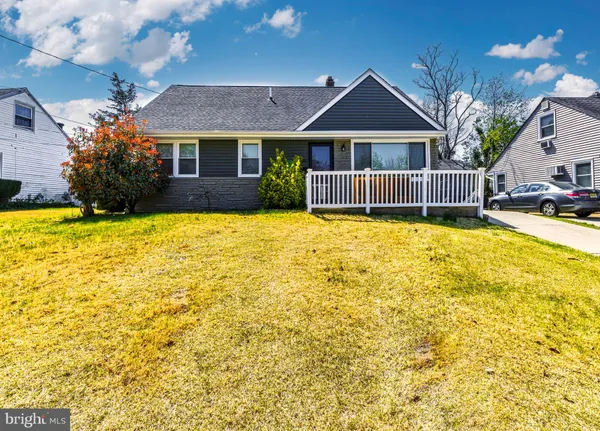 a front view of a house with swimming pool and porch with furniture