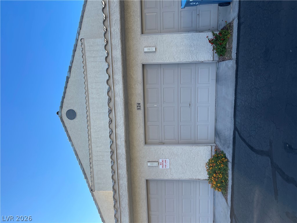 6250 West Flamingo Road, Unit 142 Las Vegas, NV 89103 - Photo 1 of 3 Attached garage parking is available at this property, featuring a classic tile roof and sturdy stucco siding.