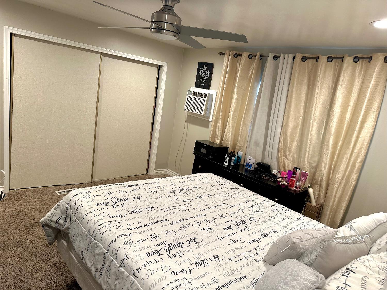 3435 Marfargoa Road, Unit 74 Stockton, CA 95215 - Photo 13 of 21 a bedroom with a bed and a mirror